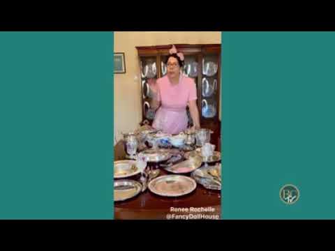 women wearing pink in standing in front of a table covered in dishes