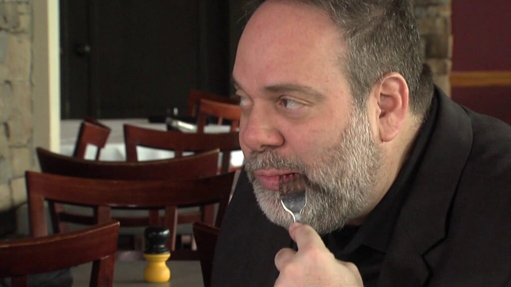 A man eating with a fork