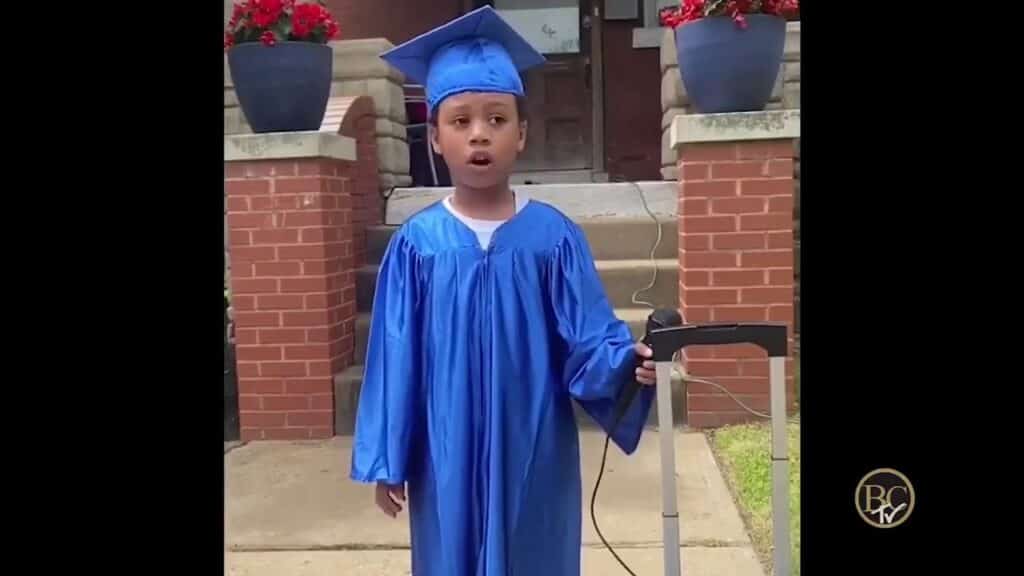 young black boy in blue graduation outfit