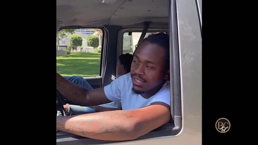 black man driving a truck