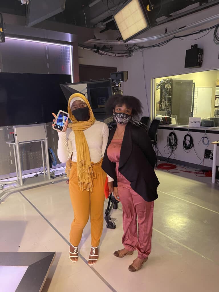 two black women holding up peace signs