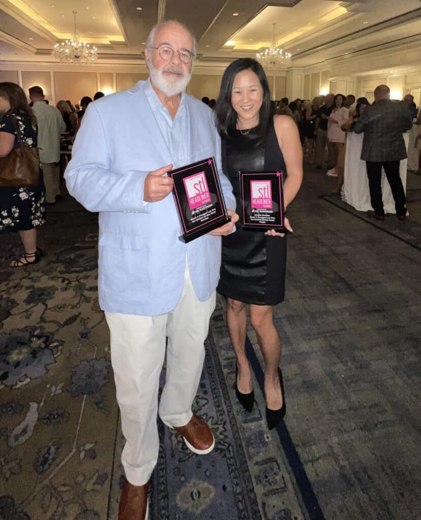 terry crouppe and jennifer pose with best law firm awards