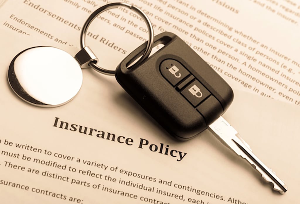 car key laying on an insurance policy