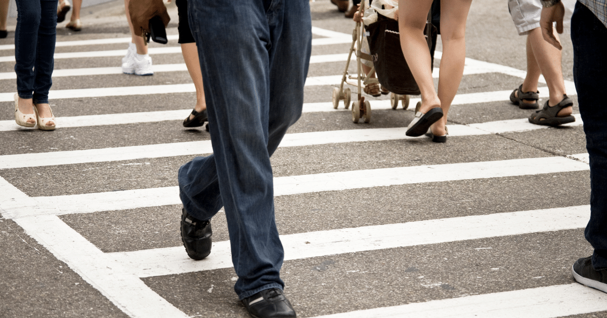 people walking across a crosswalk