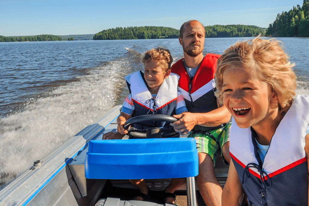 A man and his two males kids taking a boat ride