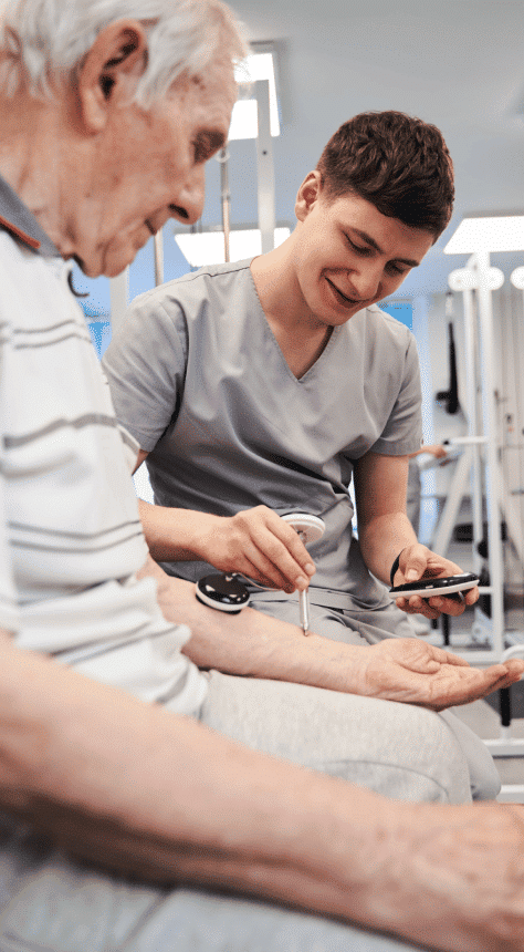 A male nurse testing a senior arm