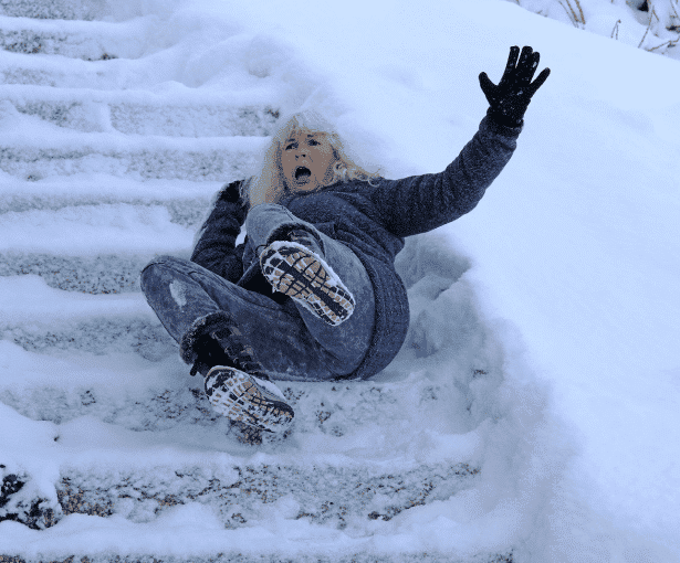 A woman slipped on the snow and fell on a rail-like surface
