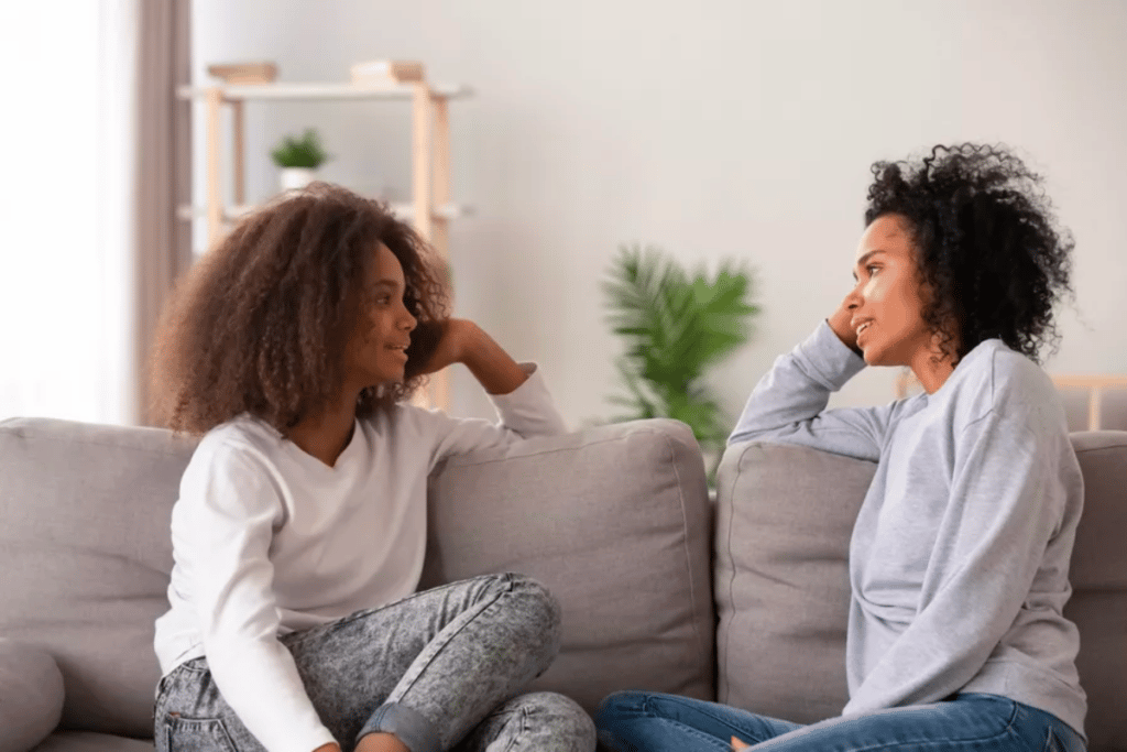 A woman talking to teenage girl