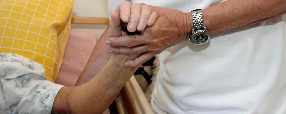 Man holding an elderly woman's hand