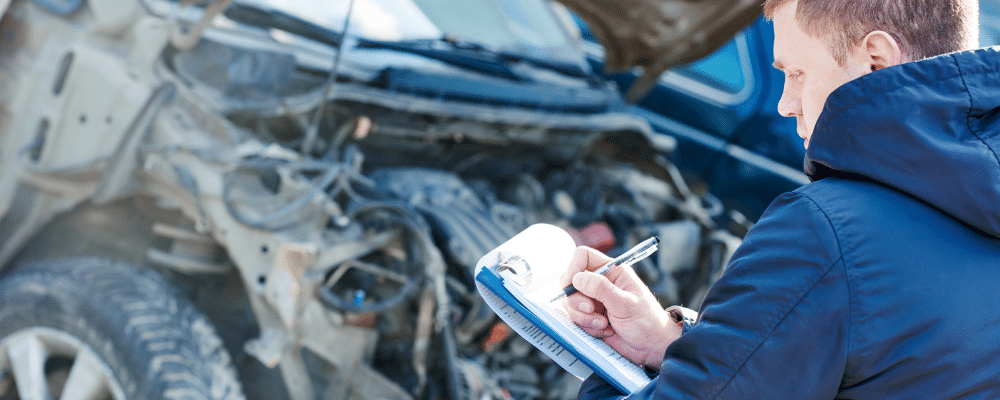 Man filling out property damage form