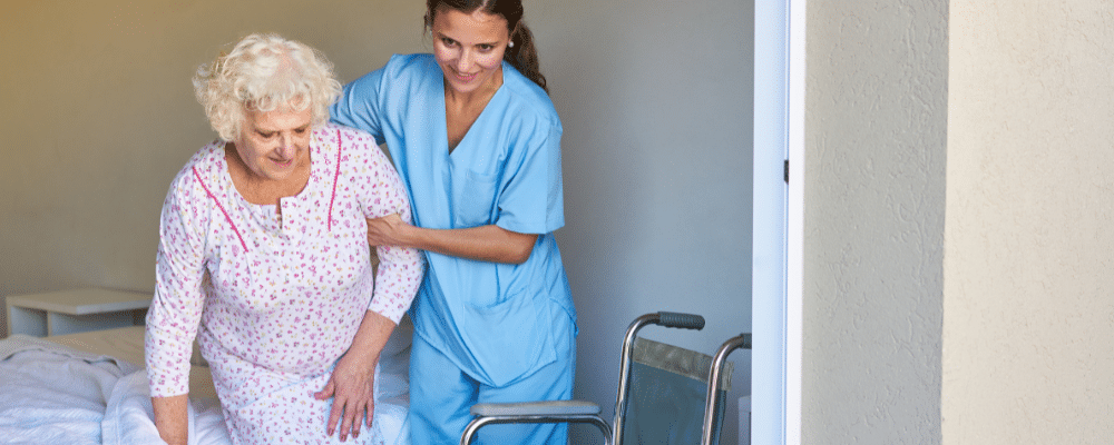 Nurse helping elderly woman
