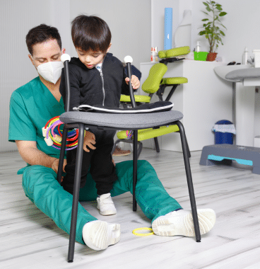 physician helping child with cerebral palsy
