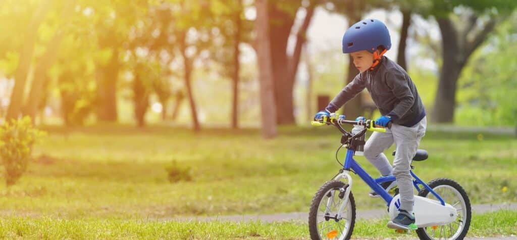 child riding bike in street