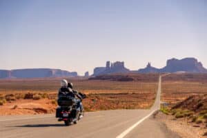 Motorcycle rider and passenger traveling together on a highway