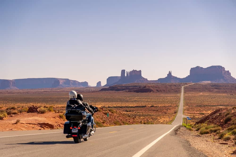 Motorcycle rider and passenger traveling together on a highway