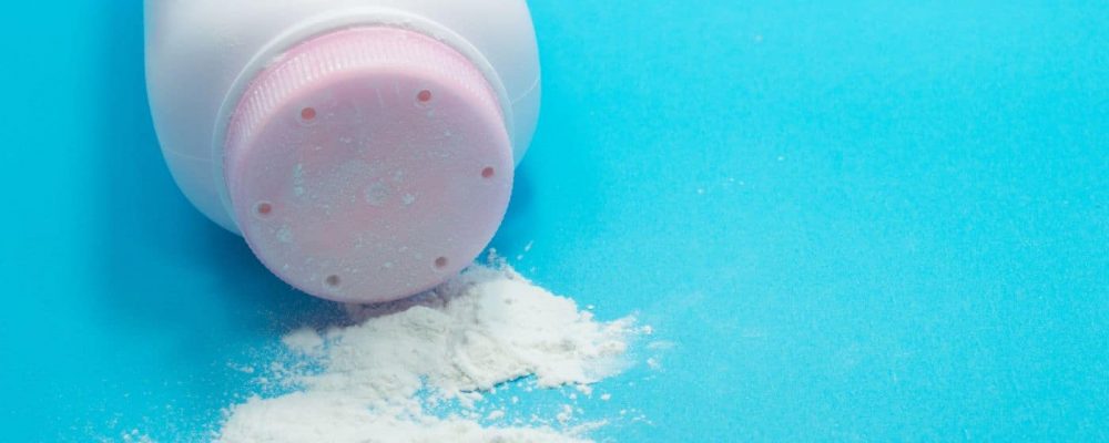 Talcom Powder Lawsuit Lawyer a bottle of talcum powder on a blue background
